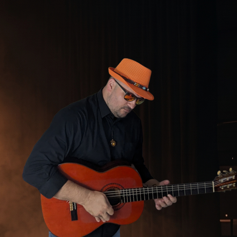 Dean the Mystic holding acoustic guitar